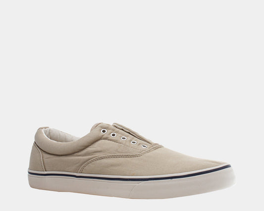 A beige sneaker with a round toe, low-top design, and lace-up closure.