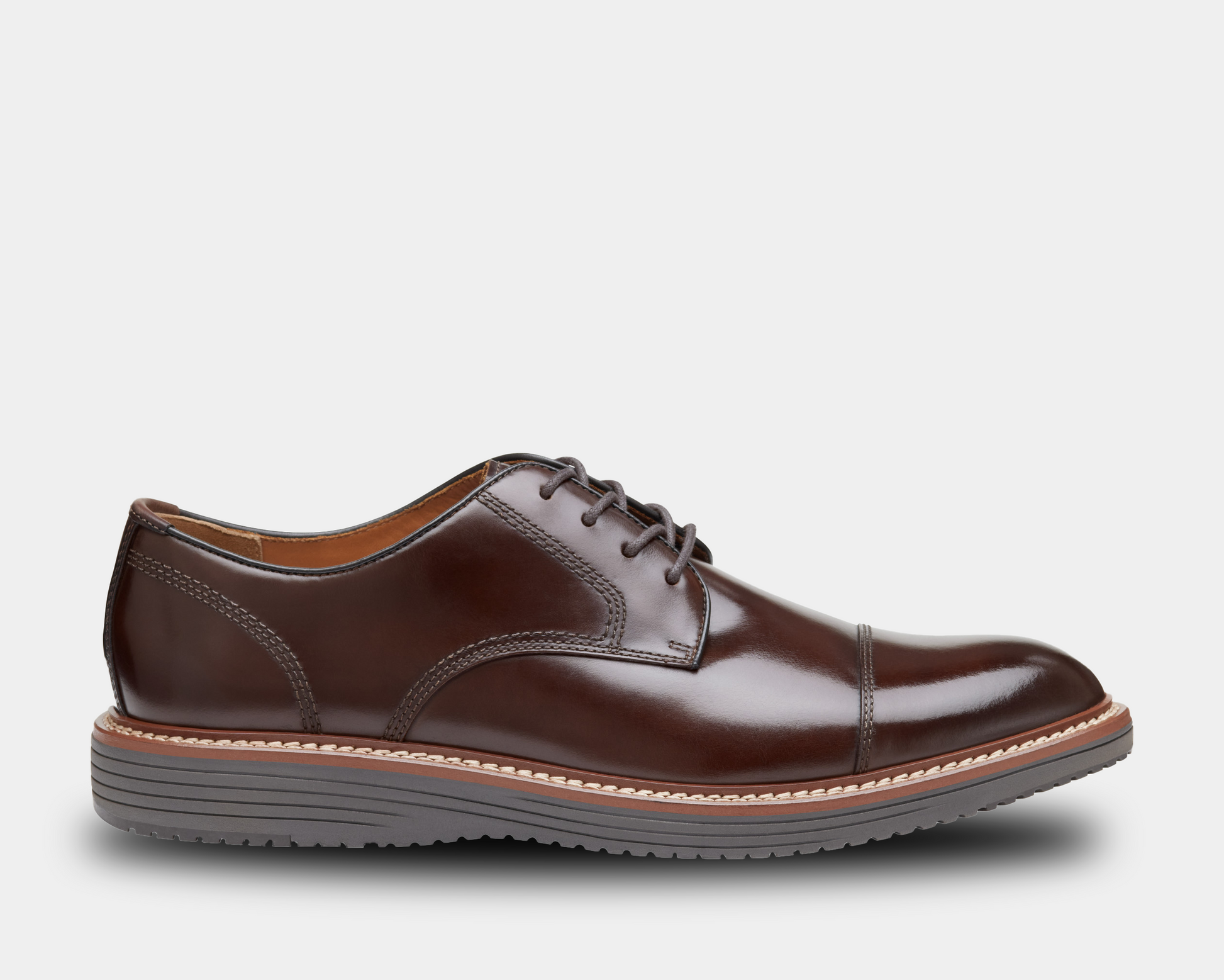 A brown full-grain leather cap toe shoe with a light brown mesh lining, featuring a leather and mesh combination sole.
